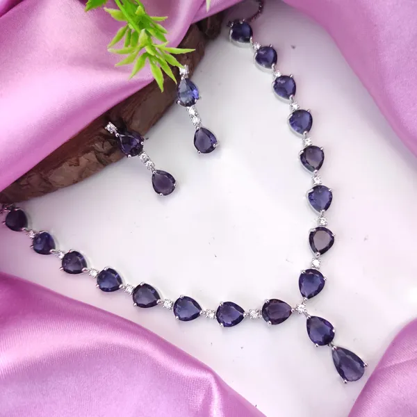 https://cdn-image.blitzshopdeck.in/ShopdeckCatalogue/tr:f-webp,w-600,fo-auto/6226f99c604c4a382408063a/media/Sara_Purple_colour_american_diamond_necklace_with_pair_earring_BTC41A82C2_2024-05-18_1.jpeg__Heera jewellers