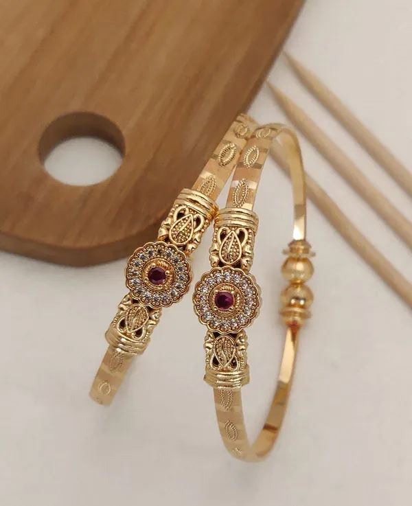 Delicate_And_Elegant_Gold_Bangles_With_A_Floral_Design_And_A_Hint_Of_Pink