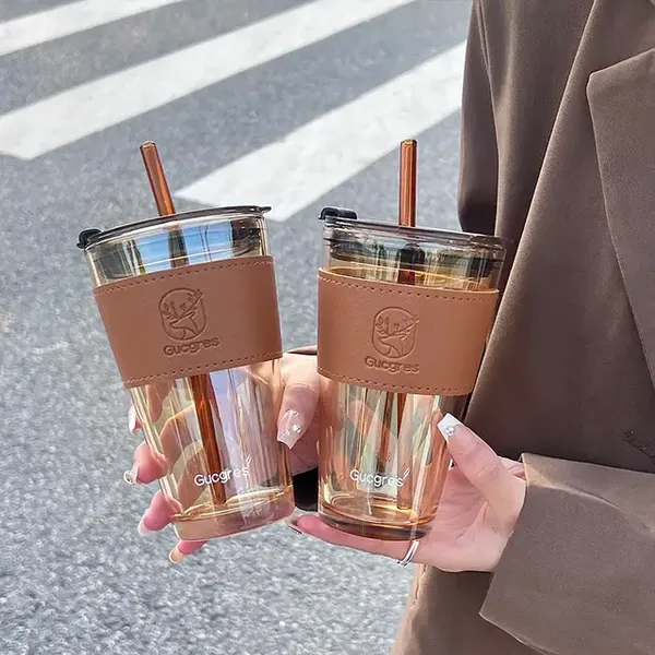 Glass_Tumblers_with_Straws_and_Lids,_Aesthetic_Coffee_Sipper_Mug_with_Leather_Sleeve,Glass_Drinking_Mason_for_Iced_Tea,_Juice,_Cocktail,_Cold_&_Hot_Beverages_Cups_Pack_of_1_(Golden)