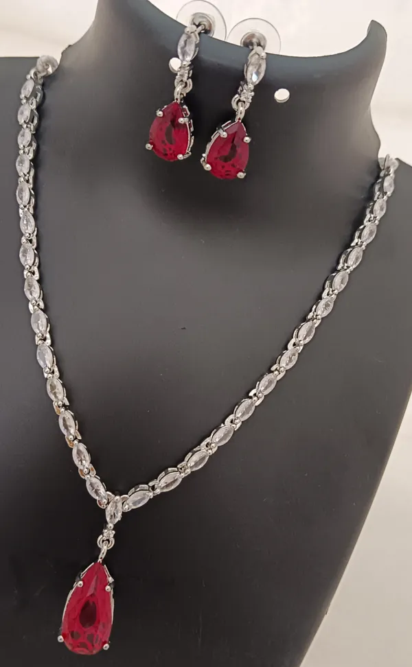 https://cdn-image.blitzshopdeck.in/ShopdeckCatalogue/tr:f-webp,w-600,fo-auto/655f446d02d8dc3ec146a77e/media/Premium_Quality_AAA_CZ_Bridal_Red_Stones_Silver_Plated_Jewellery_Set_4XE7WIT3NV_2024-04-12_1.jpg__Evy