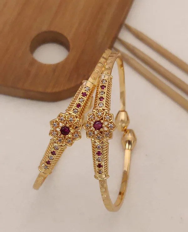 Delicate_And_Elegant_Gold_Bangles_with_A_Floral_Design_And_Sparkling_White_Stones,_Perfect_For_Any_Special_Occasion.
