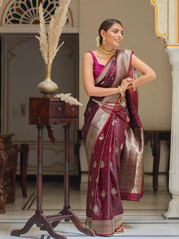 https://cdn-image.blitzshopdeck.in/ShopdeckCatalogue/tr:f-webp,w-600,fo-auto/65e1b534eddd14767aed70e6/media/Mahogany_Maroon_Kanjivaram_Silk_Saree_ZBTZBZVBB7_2024-05-29_1.jpeg__Aura Silk