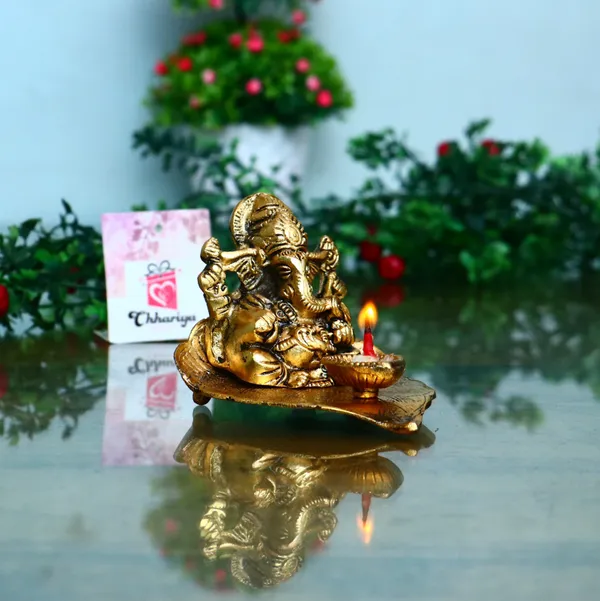 Gold_Lord_Ganesh_Sitting_On_Leaf_With_Diya_Decorative_Showpiece