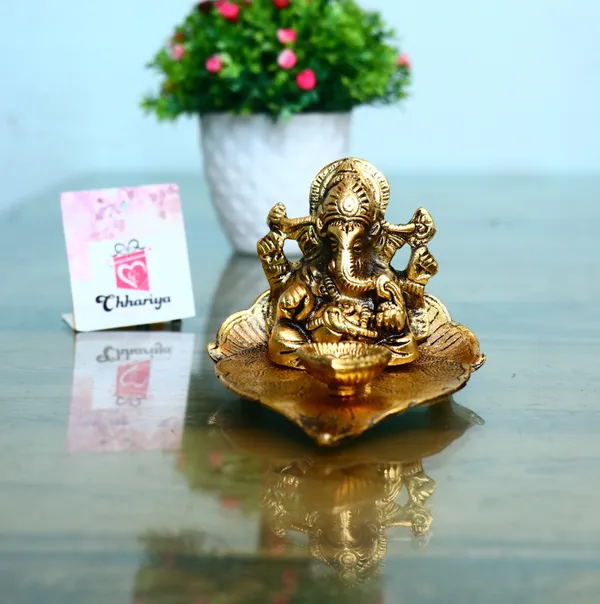 Gold_Lord_Ganesh_Sitting_On_Leaf_With_Diya_Decorative_Showpiece